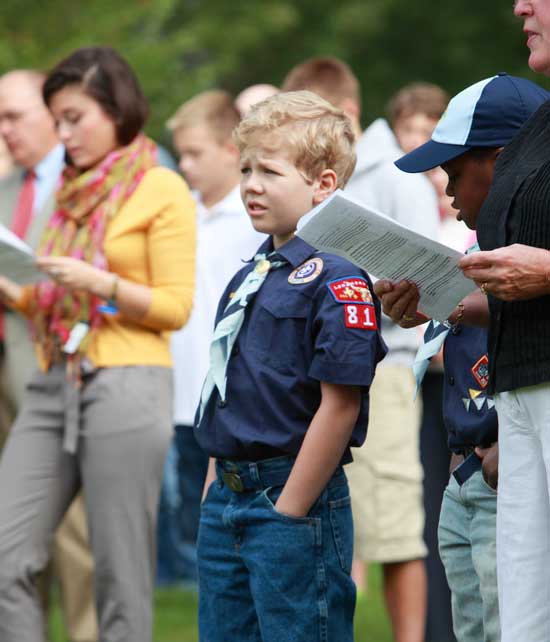 Cub Scout Nathan Woolcock listens to the service. 