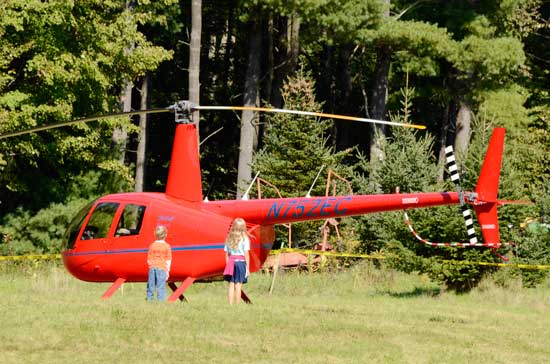 Two children check out a helicopter, part of the “touch a truck” event. (Photo by John Sharko)