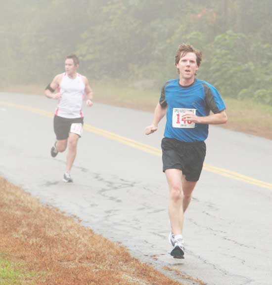 Brian Harrington of Harvard runs by Fruitlands Museum.