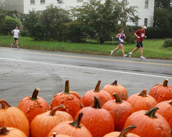 Left to right: Rich Maiore, Janet Lizotte, and Tom Daniels pass by Willard’s Farm Stand on Still River Road.