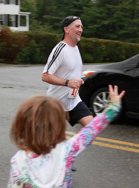 Rich Maiore finishes the last yards of his race as daughter Caroline cheers him on.