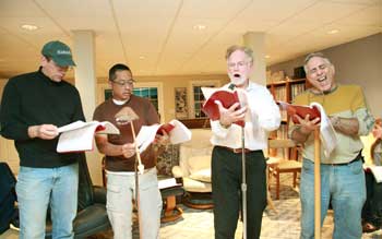 Using makeshift microphones, (from left) Tim Clark, Didi Chadran, Keith Myles, and Bob Eiland rehearse “Frankenstein” on Oct. 16. The radio play will be presented at the Harvard Public Library, Oct. 29 at 7:30 p.m. (Photo by Lisa Aciukewicz)