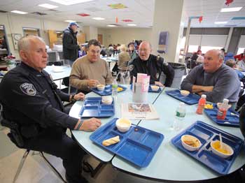 From left, Detective Jack Izzo, DPW Director Rich Nota, Officer Greg Newman, and DPW employee Bill Card take a break from their duties to eat lunch at the shelter at Bromfield. (Photo by Lisa Aciukewicz)