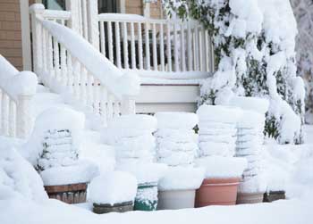 Pots stacked for winter storage get caught in the early snow. (Photo by Lisa Aciukewicz)