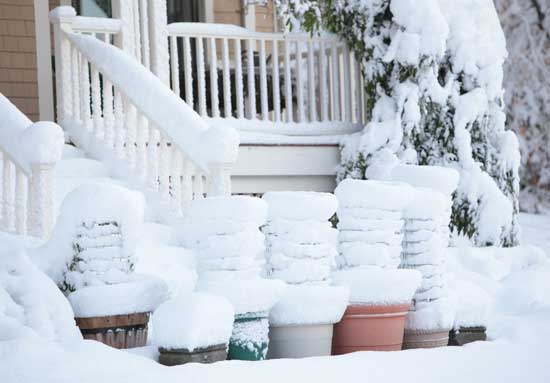 Pots stacked for winter storage get caught in the early snow. Pots stacked for winter storage get caught in the early snow.