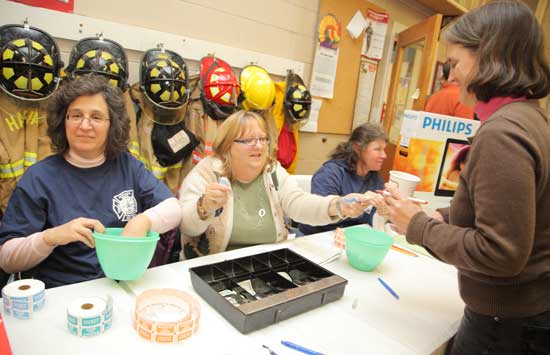 From left: Valerie Into, Janet Woodsum, and Lisa Shaw sell tickets to Rebecca Wright. From left: Valerie Into, Janet Woodsum, and Lisa Shaw sell tickets to Rebecca Wright.