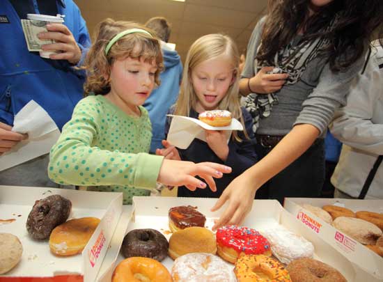 Rachael Wharton (left) and Brady Niland pick out their free doughnuts—a Turkey Raffle tradition. Rachael Wharton (left) and Brady Niland pick out their free doughnuts—a Turkey Raffle tradition.