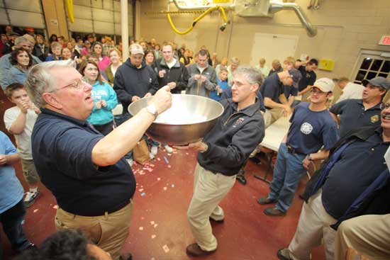 Former fire chief Peter Warren picks out a winning ticket. Former fire chief Peter Warren picks out a winning ticket.