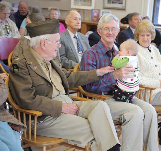 From left: James Dunlap Jr. gets the attention of his great-grandaughter, Meghan Smith, seated on the lap of her grandfather, Bob Dunlap. From left: James Dunlap Jr. gets the attention of his great-grandaughter, Meghan Smith, seated on the lap of her grandfather, Bob Dunlap.