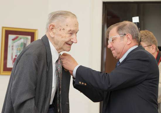 Hans Ohlin (left) receives a medal from Selectman Ron Ricci for his service in World War II at a Veterans Day ceremony at the old library Nov. 11 Hans Ohlin (left) receives a medal from Selectman Ron Ricci for his service in World War II at a Veterans Day ceremony at the old library Nov. 11