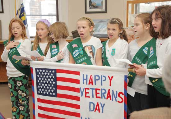 Girl Scouts sing “America the Beautiful.” From left: Shea Oldham, Fiona Morrison, Brianna Schmoyer, Olivia Noyes, Bridget Kennedy, Gianna Perini, and Samantha Schoenberg. Girl Scouts sing “America the Beautiful.” From left: Shea Oldham, Fiona Morrison, Brianna Schmoyer, Olivia Noyes, Bridget Kennedy, Gianna Perini, and Samantha Schoenberg.