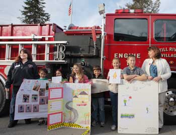 From left: Firefigher Oona Aldrich with contest winners Jack Stahl, Cecilia Juliano, Kirsten Bergen, Ethan Taylor, Ellie Reiter, Colin Murphy, and first-grade teacher Lisa Hopkins. (Photo by Lisa Aciukewicz) From left: Firefigher Oona Aldrich with contest winners Jack Stahl, Cecilia Juliano, Kirsten Bergen, Ethan Taylor, Ellie Reiter, Colin Murphy, and first-grade teacher Lisa Hopkins. (Photo by Lisa Aciukewicz)