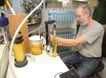 Wade Holzman bottles the final product after it has passed through the ultra-sterile cartridge. (Photo by Lisa Aciukewicz) Wade Holzman bottles the final product after it has passed through the ultra-sterile cartridge. (Photo by Lisa Aciukewicz)