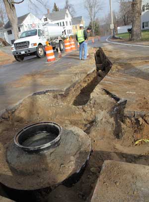 A manhole gets installed at the corner of Littleton and Fairbank streets. (Photo by Lisa Aciukewicz) A manhole gets installed at the corner of Littleton and Fairbank streets. (Photo by Lisa Aciukewicz)