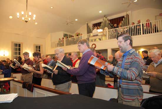 Singers warm up with a rehearsal round.