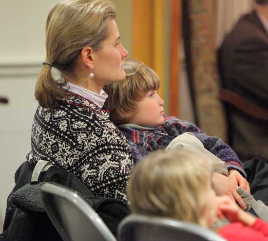 Leslie Neville listens to the music with son Wyatt on her lap