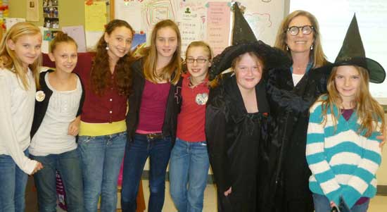 Sixth grade teacher Sharlene Tuttle poses with her students during Spirit Week. (Photo by Erin Molinaro)
