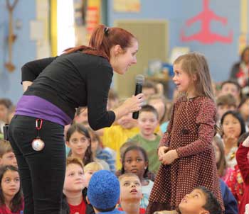 LiAnne of All for Kidz asks Danielle Lawton a question at The NED Show performance Dec. 16 at Hildreth Elementary. (Photo by Lisa Aciukewicz) LiAnne of All for Kidz asks Danielle Lawton a question at The NED Show performance Dec. 16 at Hildreth Elementary. (Photo by Lisa Aciukewicz)
