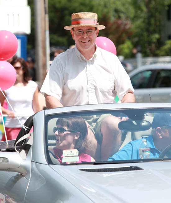 Citizen of Note Chris Ashley rides in a convertible in the Fourth of July parade. 