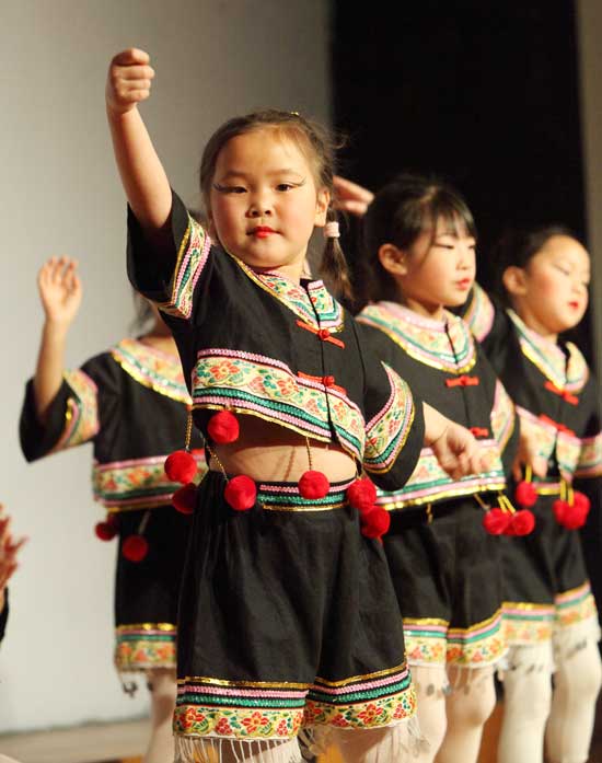 Olivia Ren performs a dance of the Yi ethnic group of Yunan Province in southern China at the Festival of Cultures at HES in March.