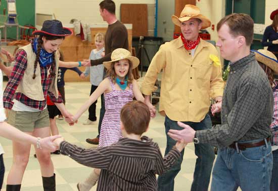 Girl Scouts and their families enjoy an April square dance.
