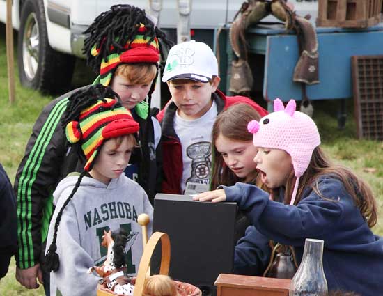 From left: Gabe Sennott, John Hawes, Patrick Flanagan, Alicia Bakis, and Madison Drummey discover a treasure at the October flea market. 