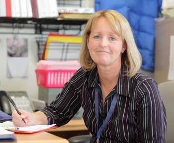 New school nurse Jenny Eklund takes a break from paper work at her desk. (Photo by Lisa Aciukewicz)
