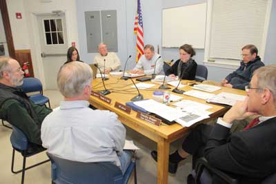 Selectmen debate the merits of conceptual drawings of Town Hall brought forward by the Municipal Building Committee and LLB Architects at a meeting Jan. 10. Clockwise from left: Wade Holtzman, Julie Doucet, Peter Warren, Ron Ricci, Marie Sobalvarro, Tim Clark, Tim Bragan, and Pete Jackson. (Photo by Lisa Aciukewicz) Selectmen debate the merits of conceptual drawings of Town Hall brought forward by the Municipal Building Committee and LLB Architects at a meeting Jan. 10. Clockwise from left: Wade Holtzman, Julie Doucet, Peter Warren, Ron Ricci, Marie Sobalvarro, Tim Clark, Tim Bragan, and Pete Jackson. (Photo by Lisa Aciukewicz)