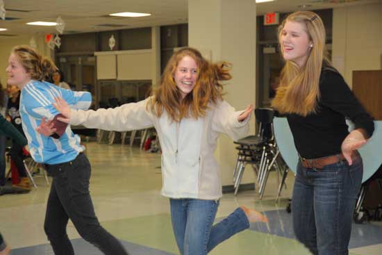 From left: Hannah Porter, Haley Newsham, and Rhett Nuenighoff polish their African dance skills.