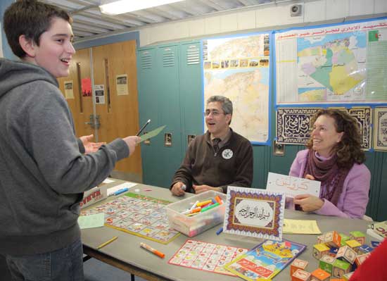 Kamil Hankour (left) and his parents Rachid Hankour and Caroline Fish share information on Algeria and the Arabic language.