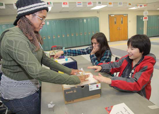 From left: Alexaleigh Colon, Tory Randall, and Evan Bilafer play paper sumo wrestling.
