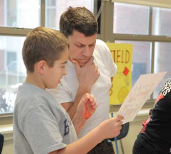 Sixth grader Aaron Hawksley seeks advice from Bruce Davidson before he starts a design. Sixth grader Aaron Hawksley seeks advice from Bruce Davidson before he starts a design.