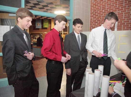  From left: Nick Norcross, Matt Polimou, Philip Kuong, and Will Sullebarger check in at the dance.