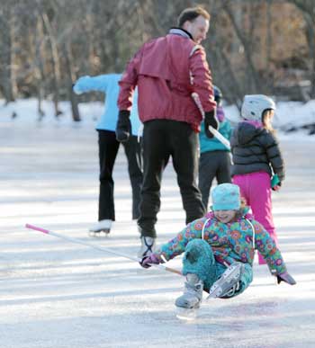 While skating at the Bolton Road fire pond on Sunday, Ella O’Neil takes a spill as she forms the caboose of the Silk family train. (Photo by Lisa Aciukewicz)