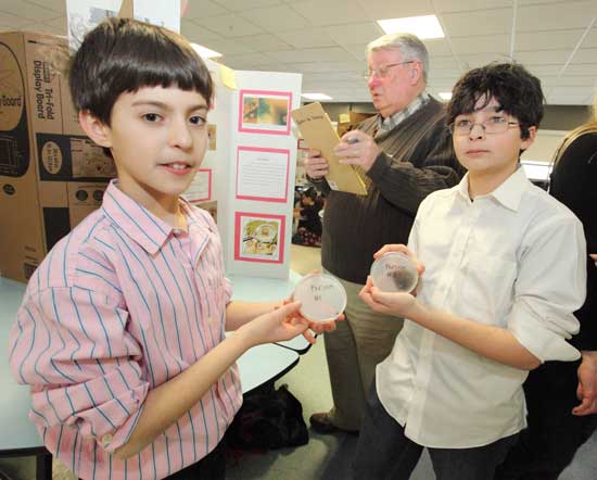 Sixth-graders Mathew Canning and David Shlimak show petri dishes from their experiment, “Whose Mouth is Cleaner? A Dog’s or a Human’s?"