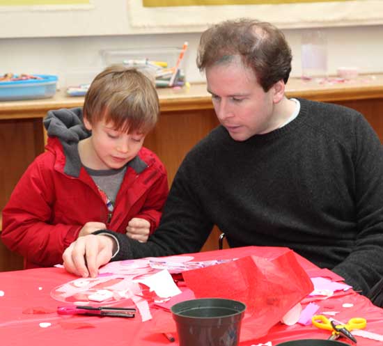 Six-year-old John Marolda makes a Valentine’s Day card with his father, Matt, at a Valentine-making event held by For Art’s Sake at the Pilot Project in the old library.