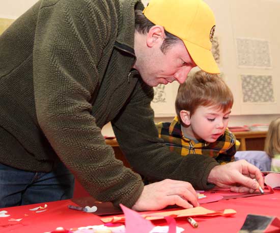 Mike Myles helps son Theo with his creation.