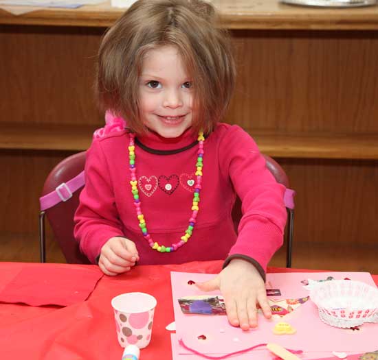 Beau Burgess-Rehm glues a heart to her card.