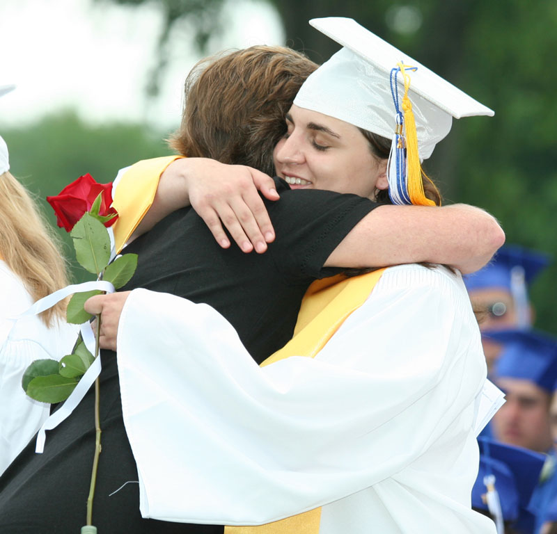 Elizabeth Malone hugs Karen Deneen as she accepts a Harvard Teachers’ Association Award.