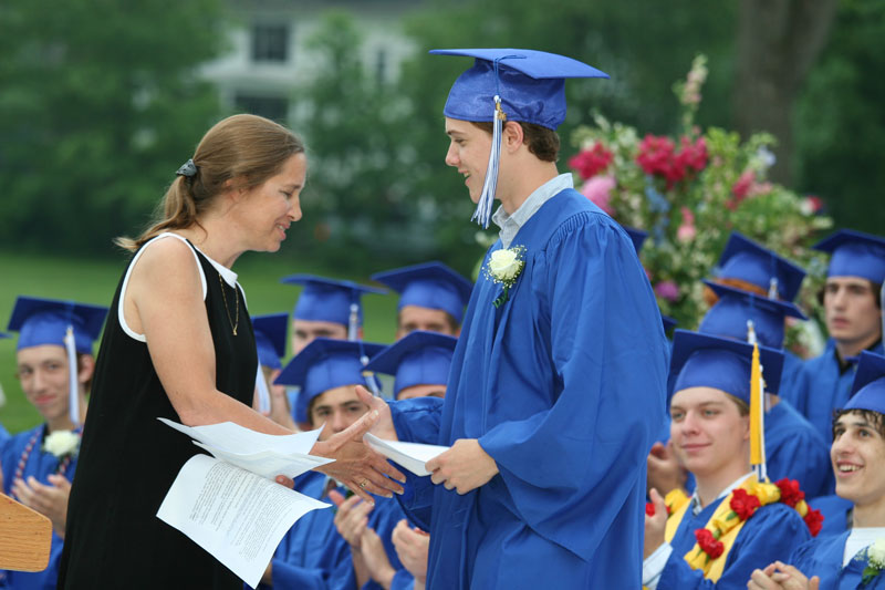 Beth Drummey shakes Sam Potter's hand as he accepts the Harvard PTA award.