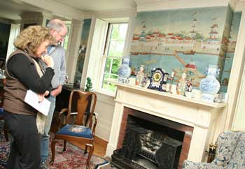 Barbara Aiello and Gordon Cook admire the stove in John Cunney and Jared Wollaston’s house during the Historical Society’s house tour. (Photo by Lisa Aciukewicz)