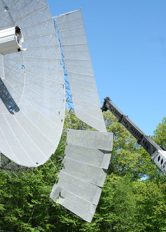 The 84-foot radio telescope dish is dismantled at Oak Ridge Observatory May 21. Although the facility is no longer listening for messages from other civilizations in our galaxy, a team is using an optical telescope there to search for possible laser-pulse messages from space. (Photo by Lisa Aciukewicz) The 84-foot radio telescope dish is dismantled at Oak Ridge Observatory May 21. Although the facility is no longer listening for messages from other civilizations in our galaxy, a team is using an optical telescope there to search for possible laser-pulse messages from space. (Photo by Lisa Aciukewicz)