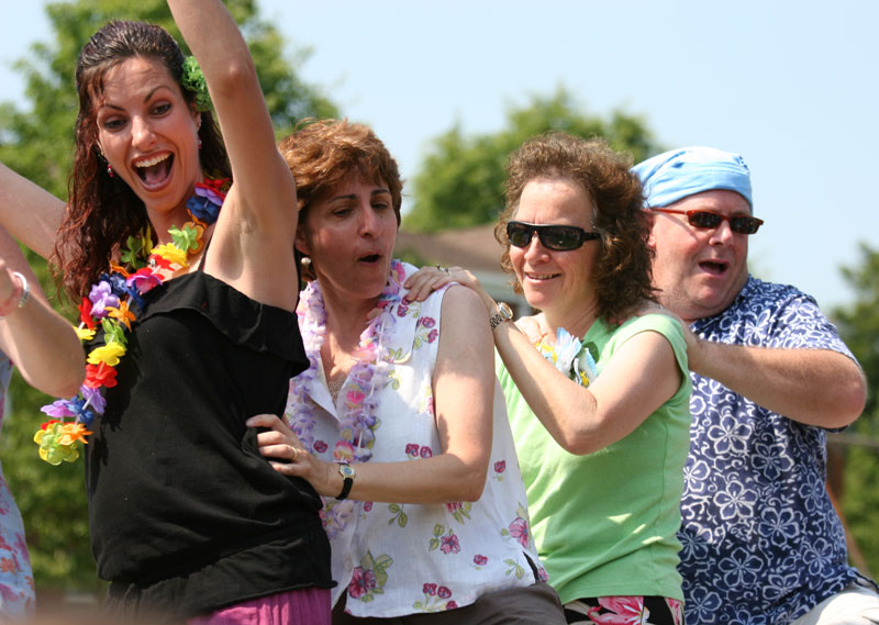 Teachers Dina Hammad, Arlene Sullivan, Judy Moore, and Rob Cullinane dance at the end-of-school luau.