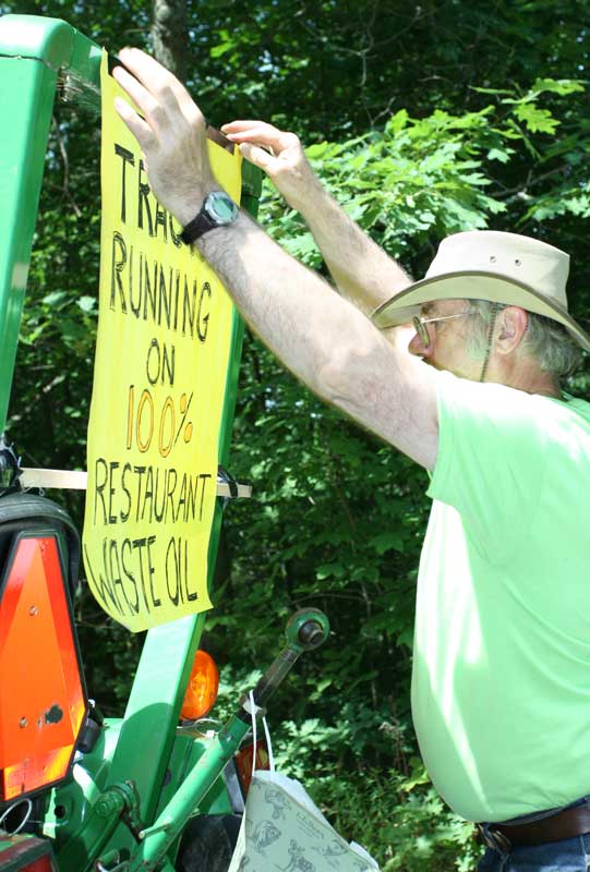Mark Kelley of Depot Road advertises that the Harvard Local float will be pulled with a tractor run on recycled restaurant oil.