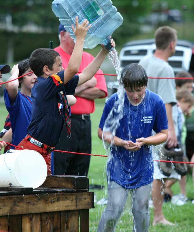 Peter Donaldson douses Aidan Aciukewicz after a relay race.