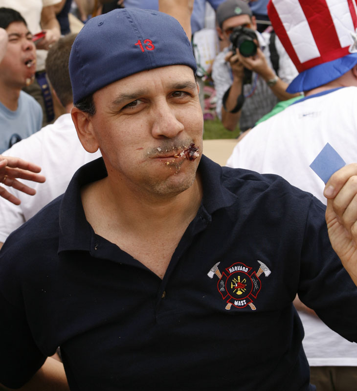 Bill Barton holds up his winning ticket for the adult heat of the pie-eating contest. (Photo by Ellen Harasimowicz)
