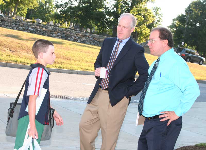Seventh-grader Sam Fishbein tells Principal Jim O’Shea and Assistant Principal Sam Hoffman about his vacation on the Outer Banks.