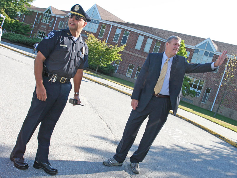 Chief Ed Denmark and Superintendent Tom Jefferson direct traffic in front of the elementary school.