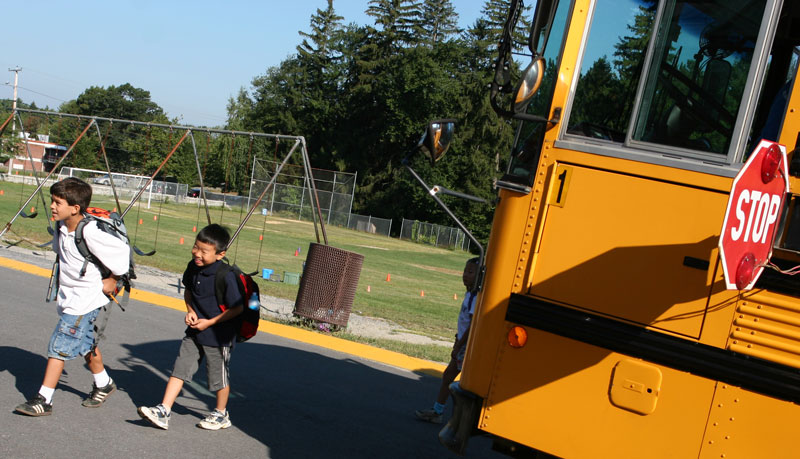 Joey D’Amore and Rainier Yano head off the bus and into the north entrance of the elementary school.