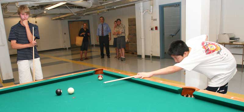 Left to right: Mike Girard, Sharon Chandler, Roy Pastor,Talia Mercandante, and Donald Girard watch as Kevin Sun prepares to sink the eight ball. Left to right: Mike Girard, Sharon Chandler, Roy Pastor,Talia Mercandante, and Donald Girard watch as Kevin Sun prepares to sink the eight ball.